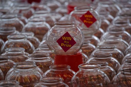 Multiple rows of glass jars of fun ball game of chance to win prizes at the Seafront Fun Fair local event in Bray, Republic of Ireland.