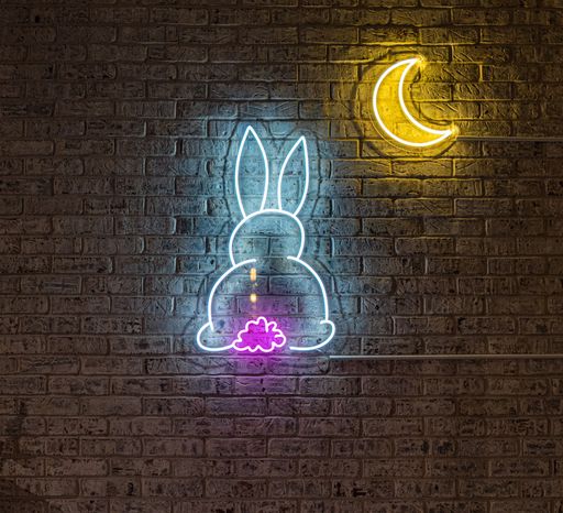 A wall decorated with a cute rabbit neon sign with the Moon