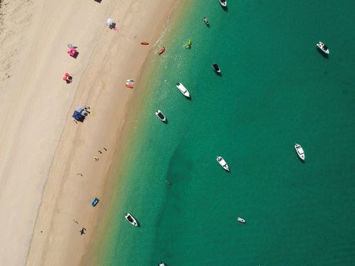 A top view of boats in a calm sea on a sunny day