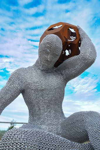 A sculpture of the man holding a ball on the Gold Coast during the Swell Sculpture Festival