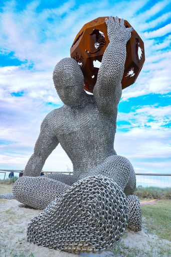 A sculpture of the man holding a ball on the Gold Coast during the Swell Sculpture Festival