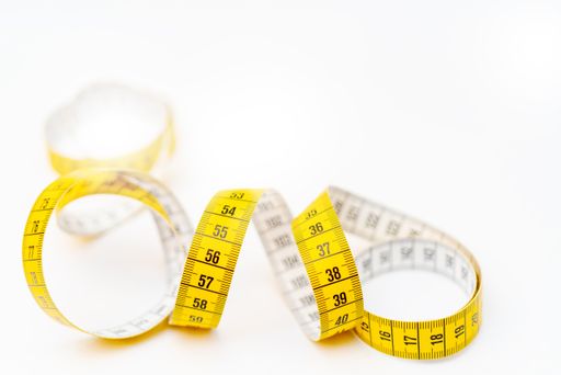 A yellow measuring tape isolated on a white background