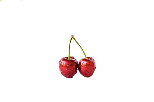 A closeup of two cherries isolated on a white background