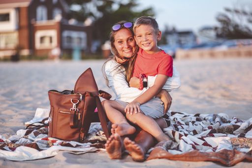 A closeup focus portrait of a mother and her son at the beach