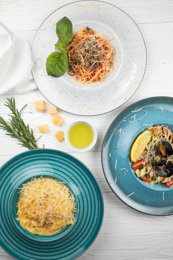 An overhead view of an assortment of freshly cooked pasta dishes