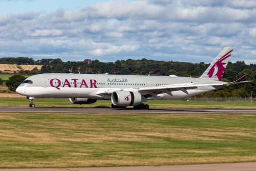 A closeup shot of a Qatar airways airplane departing at Edinburgh airport