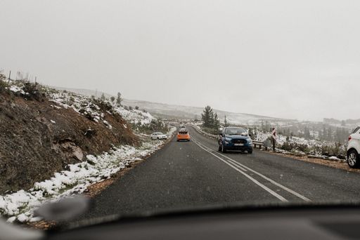 Driving in Cape Town, South Africa during winter with snow falling.