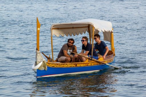 A beautiful shot of Maltese Dghajsa carrying tourists in the Grand Harbor Valletta