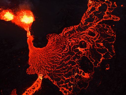 A beautiful shot of lava flowing from a volcano at night in Iceland