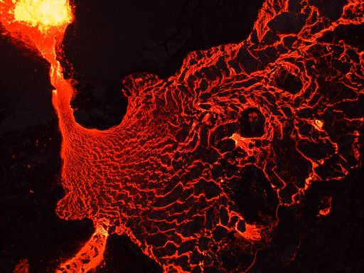 A beautiful shot of lava flowing from a volcano at night in Iceland