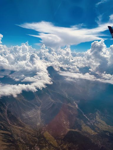 a airplane travel in high altitude and crossing kashmir mountains and clouds