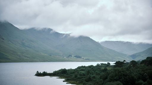 A beautiful landscape over Connemara Lake and mountains in Ireland on a foggy day