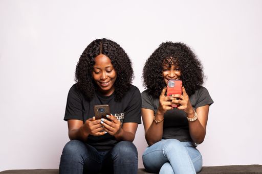 two black girls using their phones