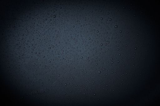A closeup shot of waterdrops on a hard surface - great for background