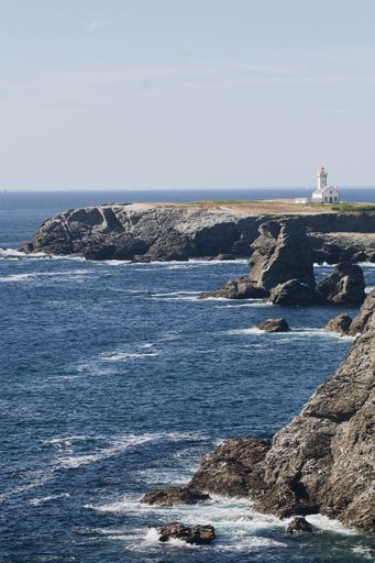 Scenic shot of Poulains lighthouse on coast of the Atlantic Ocean at the northern tip of Belle Ile, Brittany, France