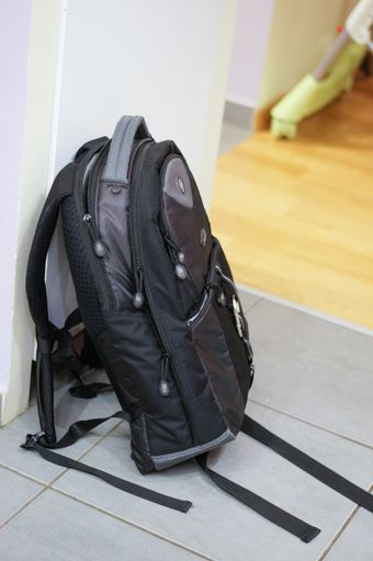 Dicota black computer bag on tiles floor