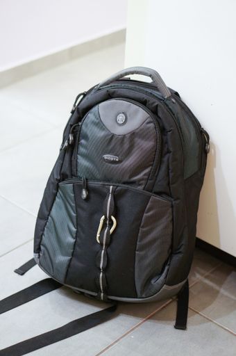 Dicota black computer bag on tiles floor