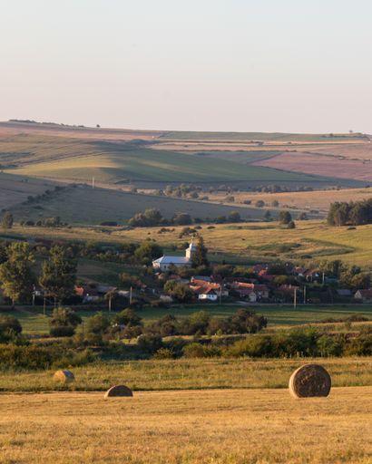 An aerial shot of a small village in an amazing mountain landscape in Transylvania, Romania