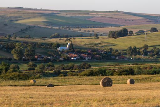 An aerial shot of a small village in an amazing mountain landscape in Transylvania, Romania