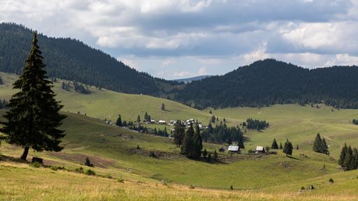 An aerial shot of a small village in an amazing mountain landscape in Transylvania, Romania