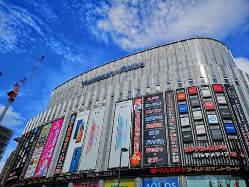 A low angle shot of Yodobashi Store against a cloudy blue sky in Akihabara, Tokyo, Japan