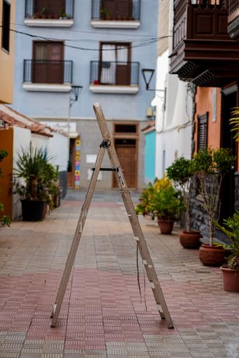 A vertical shot of wooden stairs in a modern colorful street during daytime