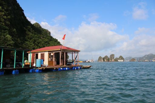A cottage at the end of a pier on the ocean near the