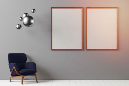 An empty room with a chair and two framed art pieces on the wall, with copy space