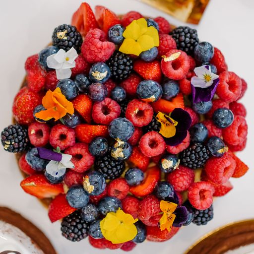 A top view of fresh berries decorated with flowers