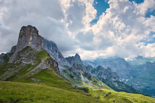 Beautiful aerial view of a green landscape with mountains and a cloudy sky