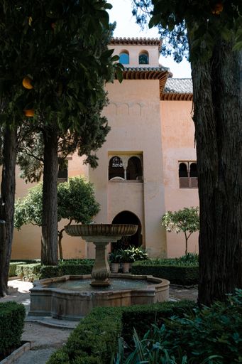 A vertical shot of a water fountain near the entrance of the Alhambra Granada Spain