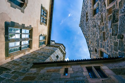 A low angle shot of the exterior of stone building under the blue sky