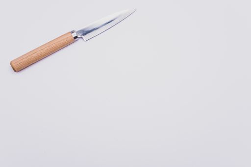 A closeup of a kitchen knife isolated on a white background