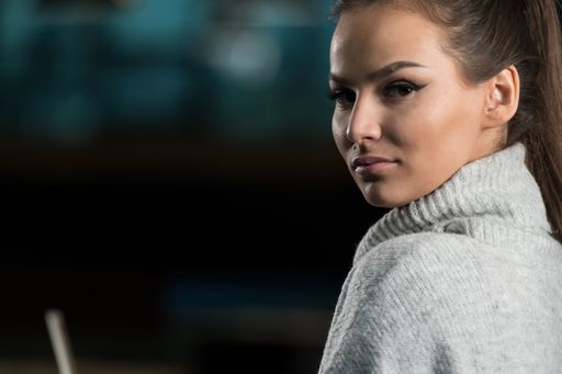 A closeup of a beautiful young woman looking at the camera.