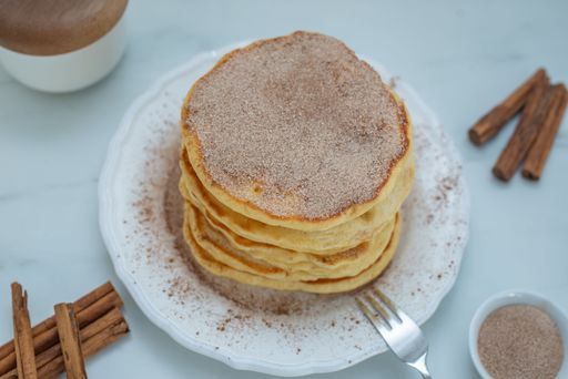 The tasty cinnamon pancakes served on a plate with vanilla