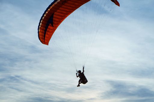 Close up shot of paraglider pilot in blue sky near Cologne, Germany