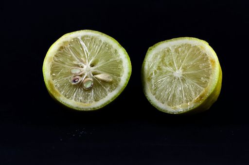 A cut lemon isolated on black background