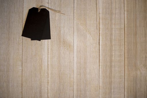 An overhead shot of a blank tag on a wooden surface -great for background or writing text
