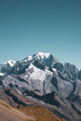 A vertical shot of the beautiful Mont Blanc with its snowy peaks under a clear sky in the French Alps