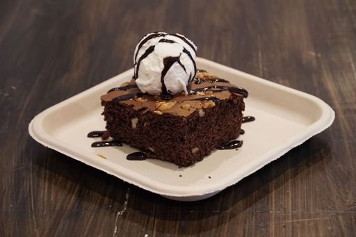 A closeup shot of a chocolate brownie with ice cream in the cafe