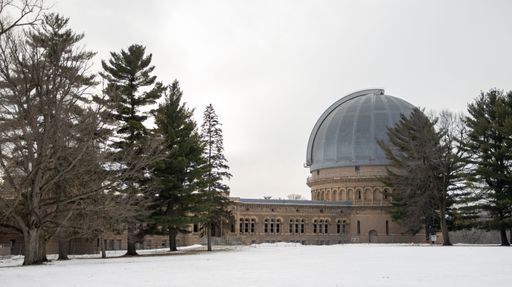 A wide shot of the Yerkes Observatory under cloudy sky in winter in Williams Bay, Wisconsin, USA