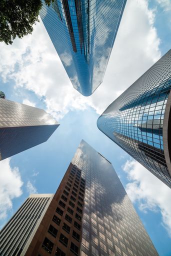 A vertical low-angle shot of skyscrapers in downtown Los Angeles