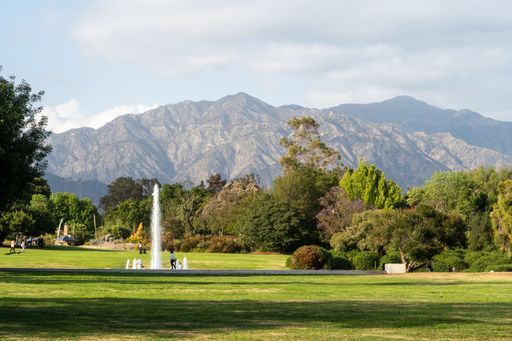 The Los Angeles County Arboretum and Botanic Garden with a fountain and mountains in the background