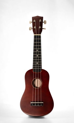 Vertical shot of Ukelele standing upright against bright white background