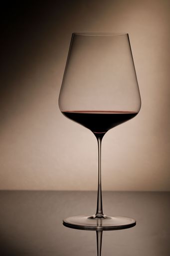 A vertical shot of a glass of red wine