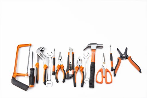 A top view of an orange and black mechanic hand tool set against a white background