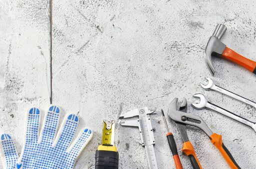 A top view of an orange and black mechanic hand tool set against a white background