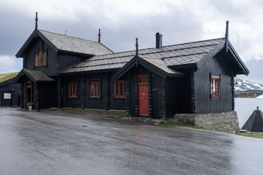 Wonderful landscapes in Norway. Vestland. Beautiful scenery of houses with grass roof. Norwegian traditional architecture. Mountains, rocks and snow
