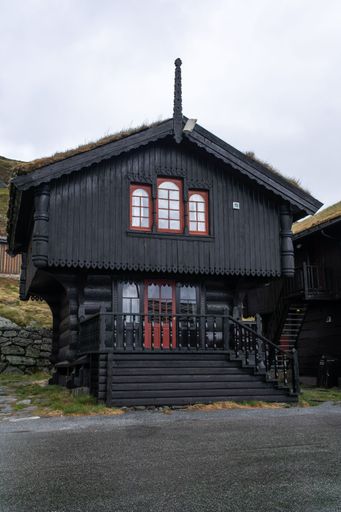Wonderful landscapes in Norway. Vestland. Beautiful scenery of houses with grass roof. Norwegian traditional architecture. Mountains, rocks and snow