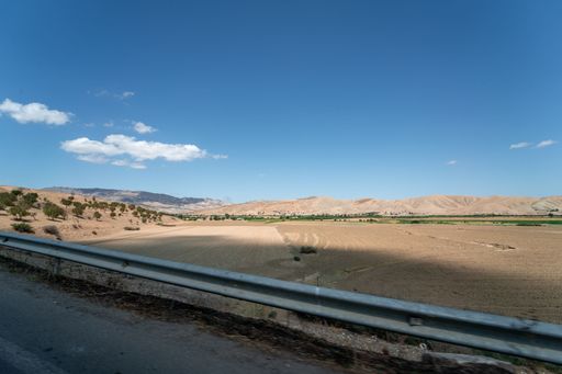 Car window passing by a rural area